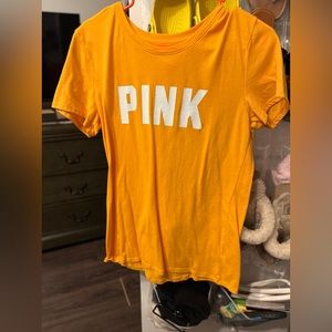 A pink yellow shirt white white writing